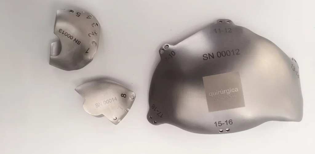 Two titanium cranial implants with engraved serial numbers